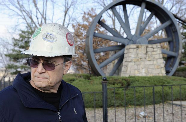 Former steel worker Joe Soptic stands near a giant drive wheel December 15, 2011 that was used by a steel mill that closed due to bankruptcy in 2001 and is now thought of as a memorial to the days that Kansas City, Missouri had a vibrant steel industry