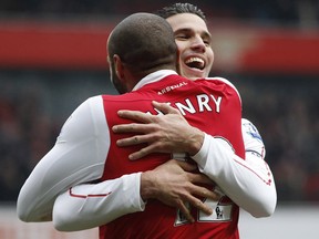 Robin Van Persie is hugged by teammate Thierry Henry during Arsenal's convincing 7-1 win over Blackburn Sunday. The Dutch striker scored in the second, 38th and 62nd minute to bring his league total to 22.