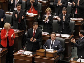 Premier Dalton McGuinty and MPs applaud Ontario Finance Minister Dwight Duncan after he delivered the provincial budget at Queens Park in Toronto, March 27, 2012. REUTERS/Mark Blinch (CANADA  - Tags: POLITICS BUSINESS)