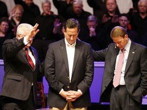 Republican presidential hopeful Rick Santorum (C) receives a blessing at Greenwell Springs Baptist Church in Louisiana, March 18, 2012.