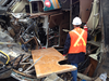 A TSB investigator examining the wreck of the Via locomotive cab.