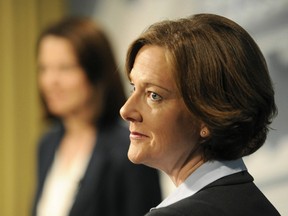 Progressive Conservative leader Alison Redford waits to debate with Wildrose leader Daniel Smith, background, prior to a televised leaders' debate in Edmonton April 12, 2012. Albertans will be going to the polls on April 23 in a provincial general election