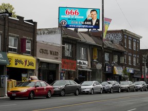 A billboard on Bloor Street West in Toronto shows Jose Luis De Jesus. The sect leader's followers believe he is the incarnation of Christ.