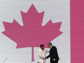Peru's President Ollanta Humala (L) and Canada's Prime Minister Stephen Harper shake hands during the CEO Summit as part of the Americas Summit in Cartagena April 14, 2012. Heads of state are meeting in Cartagena from April 14-15.       REUTERS/Chris Wattie       (COLOMBIA)