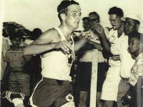 Doug Kyle, founder of the Calgary Marathon, crosses the finish line in one of the earliest races.