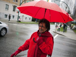 Dr. Hedy Fry, Liberal MP for Vancouver Centre, waves to cars in downtown Vancouver, British Columbia in a file photo.