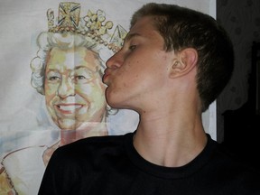 Adam Sharp kisses a portrait of the Queen.