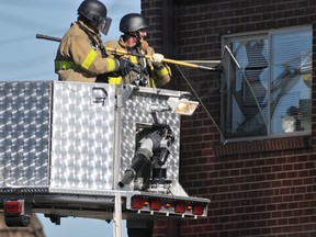 Booby trap warning: Police break the window of the apartment believed to belong to James Holmes, the suspect in the Dar Knight Rises movie shooting.