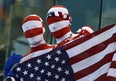 Two American fans hold up their flag at the Aquatic Centre at the 2012 Summer Olympics in London on Tuesday, July 31, 2012. THE CANADIAN PRESS/Sean Kilpatrick