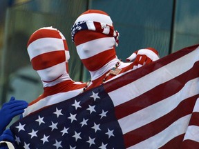 Two American fans hold up their flag at the Aquatic Centre at the 2012 Summer Olympics in London on Tuesday, July 31, 2012. THE CANADIAN PRESS/Sean Kilpatrick