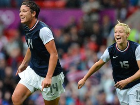 Forward Abby Wambach, at left, celebrates with teammate midfielder Megan Rapinoe after scoring during the London 2012 Olympic Games women's football match between the U.S. and North Korea on July 31, 2012.