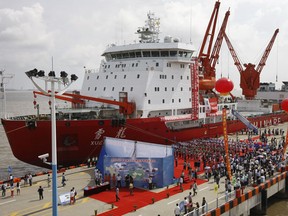 In this photo provided by China's Xinhua News Agency,  Chinese icebreaker Xuelong, or Snow Dragon, is harbored in Shanghai,  after an 85-day scientific quest across the Arctic ocean, Thursday, Sept. 27, 2012.  The Chinese icebreaker has docked at Shanghai after becoming the first Chinese vessel to cross the Arctic Ocean. (AP Photo/Xinhua, Pei Xin) NO SALES