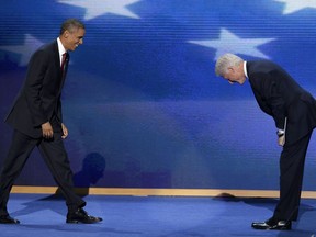 Former President Bill Clinton bows as President Barack Obama walks on stage after Clinton's address to the Democratic National Convention in Charlotte, N.C., on Wednesday, Sept. 5, 2012. (AP Photo/J. Scott Applewhite)
