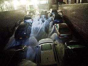NEW YORK, NY - OCTOBER 29:  Rising water, caused by Hurricane Sandy,  rushes into a subterranian parking garage on October 29, 2012, in the Financial District of New York, United States. Hurricane Sandy, which threatens 50 million people in the eastern third of the U.S., is expected to bring days of rain, high winds and possibly heavy snow. New York Governor Andrew Cuomo announced the closure of all New York City will bus, subway and commuter rail service as of Sunday evening  (Photo by Andrew Burton/Getty Images)