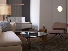 A neutral-toned Loft Suite. The opaque porthole window is on the door to the bathroom.