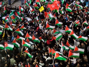 Palestinians celebrate in the streets of Ramallah on Thursday. (Uriel Sinai/Getty Images)