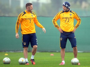 David Beckham, right, began a trend that has seen many notable names in soccer join the MLS, including Los Angeles Galazy teammate Robbie Keane. (Harry How/Getty Images)