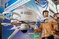 A man adjusts the display of a Chinese-made drone equipped with a surveillance camera during the 9th China International Aviation and Aerospace Exhibition in Zhuhai.