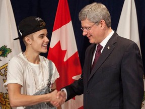 Prime Minister Stephen Harper was happy to present Justin Bieber with a Diamond Jubilee Medal on Friday, November 23, 2012 (PM Stephen Harper's Photostream/Flickr)