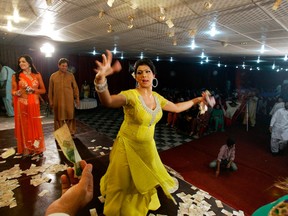 A man offers money to Sonia, 26, a transgender Pakistani, while dancing at a birthday party in Rawalpindi, Pakistan. (AP Photo/Anjum Naveed)