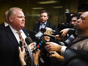Rob Ford arrives at his office in Toronto November 26, 2012. The mayor was ordered removed from office on Monday after a judge found him guilty of breaking conflict-of-interest laws.