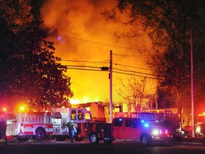 Flames and smoke billow from a home in west Jackson, Miss., Tuesday evening, Nov. 13, 2012, after authorities say a small plane carrying three people crashed into the residence shortly after 5 p.m. (AP Photo/The Clarion-Ledger, Joe Ellis) NO SALES