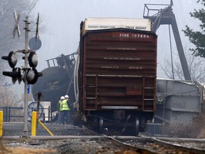 Officials stand next to derailed freight train cars in Paulsboro, N.J., Friday. (AP Photo/Mel Evans)
