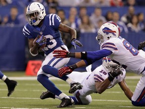 Indianapolis Colts wide receiver T.Y. Hilton, left, has benefited from the guidance of Reggie Wayne in studying off the field and spreading the defence on it. (AJ Mast/The Associated Press)