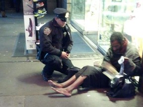 The photo of homeless man Jeffrey Hillman accepting a pair of boots from NYPD officer Lawrence DePrimo on a cold November night near Times Square has become an Internet sensation. But it turns out Hillman, a military veteran, isn't actually homeless (Facebook)