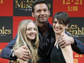 Amanda Seyfried, Hugh Jackman and Anne Hathaway pose at a promotional event for Les Miserables in Tokyo.