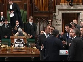 Defence Minister Peter MacKay steps in to try to defuse the situation in the House of Commons Wednesday.