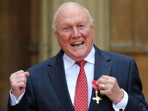 In this file picture taken on March 22, 2012 British presenter Stuart Hall poses with his Officer of the British Empire (OBE) medal presented to him by Britain's Queen Elizabeth II at an investiture ceremony in Buckingham Palace. British prosecutors said on December 5, 2012 they were bringing charges against veteran BBC commentator Hall, saying he indecently assaulted children in the 1970s and 1980s. The 82-year-old, a former presenter of game show "It's a Knockout" known for his eccentric and erudite football match summaries on BBC Radio 5 Live, was arrested at his home Wilmslow near Manchester in northwest England earlier in the day.  (Stefan Rousseau / AFP / Getty Images)