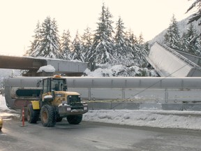 One of three CN train cars that derailed eight kilometres south of Pemberton, B.C. blocks the southbound lane of Highway 99 on Thursday, Jan. 3, 2013. THE CANADIAN PRESS/ Bonny Makarewicz