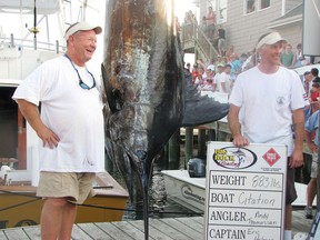 Citation angler Andy Thomossan, left, and Eric Holmes stand with the 883-pound blue marlin they caught in the Big Rock Blue Marlin Tournament in Morehead City, N.C.