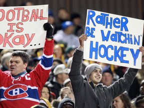 Dave Chidley / the canadian press
Fans holds signs commenting on the NHL lockout during a CFL game in Hamilton, Ont., on Friday, Oct. 12, 2012.