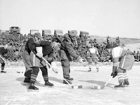 Brigadier John Rockingham drops the puck for a match between 1st Battalion, Princess Patricia’s Canadian Light Infantry (left) and 2nd Battalion, Royal 22e Regiment “Vandoos” (right) during the Korean War. Playing for the Patricias was Private W. Wolfe. For the Royal 22e Regiment, Private R. Halley.