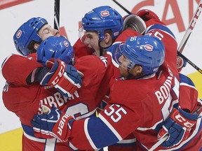 Montreal's Brandon Prust, left, celebrates with teammates P.K. Subban, Alex Galchenyuk and Francis Bouillon after opening the scoring in third period on Monday night.