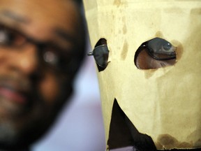 A gay Ugandan man, later granted asylum in the U.S., hides his identity during a press conference in Washington in 2010. Canada is fighting a proposed bill in Uganda that could make homosexuality punishable by death in some cases.