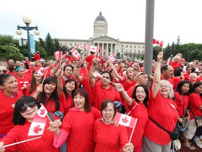 Thousands of Winnipeggers wearing red shirts wave Canadian flags at the Legislature grounds while forming human flag Friday morning as part of Canada Day Celebrations.
July 1 2011
(RUTH BONNEVILLE / WINNIPEG FREE PRESS)