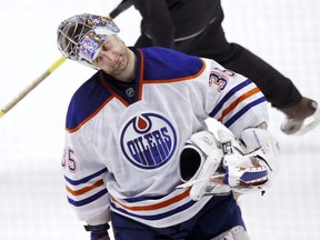 Edmonton Oilers goalie Nikolai Khabibulin (35), of Russia, returns to the net during a break in the action in the second period of an NHL hockey game against the Chicago Blackhawks, Monday, Feb. 25, 2013, in Chicago. (AP Photo/Charles Rex Arbogast)