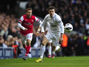 Tottenham Hotspur's Welsh midfielder Gareth Bale (R) chases the ball during the English Premier League football match between Tottenham Hotspur and Arsenal at White Hart Lane in north London on March 3, 2013. AFP PHOTO/GLYN KIRK  RESTRICTED TO EDITORIAL USE. No use with unauthorized audio, video, data, fixture lists, club/league logos or ‚Äúlive‚Äù services. Online in-match use limited to 45 images, no video emulation. No use in betting, games or single club/league/player publicationsGLYN KIRK/AFP/Getty Images