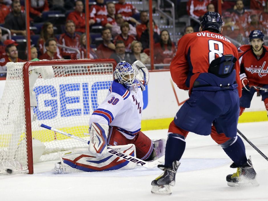 New York Rangers's goalie Henrik Linqvist stops the puck hit by