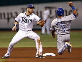 Tampa Bay Rays second baseman Ben Zobrist, left, waits to tag out the Toronto Blue Jays' Maicer Izturis on an attempted steal of second base to complete a double play after the strikeout of batter Henry Blanco during the fourth inning.