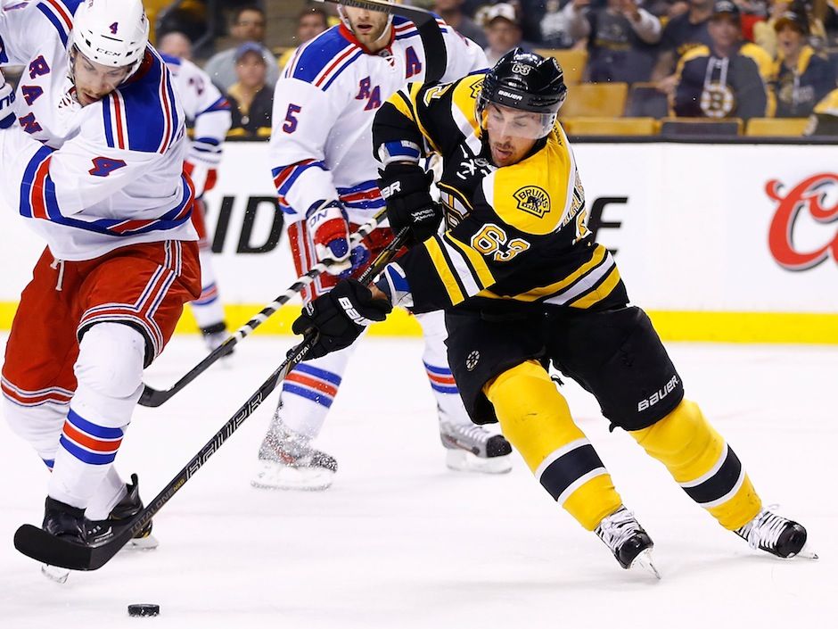 Boston Bruins' Torey Krug gets off a pass as he falls to the ice during the  first period of an NHL hockey game against the Pittsburgh Penguins in  Pittsburgh, Sunday, March 10