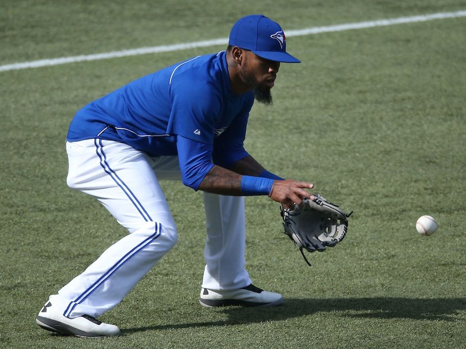 Toronto Blue Jays' Jose Reyes laughs toward the bench after