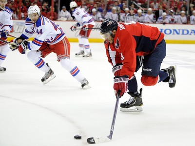 New York Rangers Ryan Callahan (24) is hit hard into the boards by