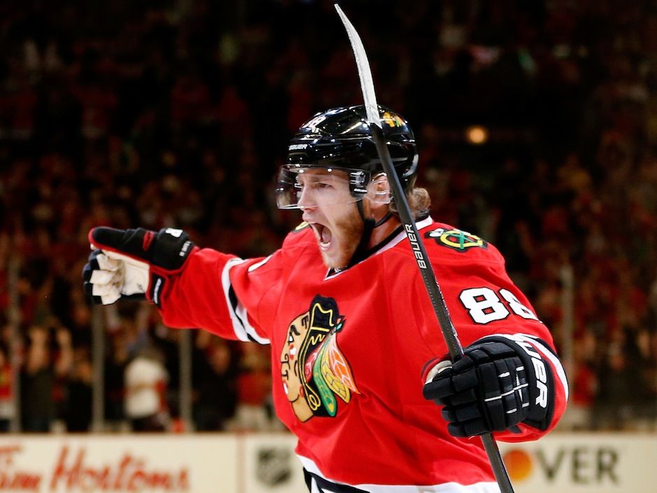Patrick Kane waves to the crowd after winning the Cup