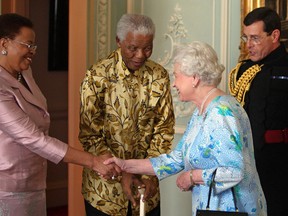 Former South African president Nelson Mandela (2nd L) and his wife Graca Machel (L) meet Britain's Queen Elizabeth II (2nd R) at Buckingham Palace, in central London, on June 25, 2008. Nelson Mandela arrived in Britain Monday June 23, 2008 ahead of a 90th birthday concert in his honour in London's Hyde Park. The three-hour gig on Friday, headlined by veteran rockers Queen alongside the likes of Razorlight and Simple Minds, will also support Mandela's 46664 campaign against HIV/AIDS. AFP PHOTO/Dominic Linpinski/POOL (Photo credit should read Dominic Lipinski/AFP/Getty Images)