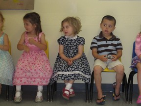 Zara MacDonald, centre, sits between classmates Hailey Peddle and Evan Foran at the Village of Brooklin Co-Operative Playschool graduation, June 24, 2013.