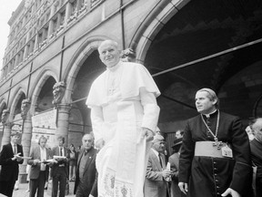 BELGIUM OUT - This file picture dated 17 May 1985, shows Roger Vangheluwe (R) during the visit of late Pope John Paul II (C) to the city of Ieper (Ypres). On April 22, 2010 Brugges' bishop Roger Vangheluwe tendered his resignation amid speculation of phedophilia. The announcement by head of Belgium's catholic church Andre-Joseph Leonard comes in the wake of some 300 formal complaints for acts of pedophilia brought to light in Belgium earlier this month. AFP PHOTO / BELGA PHOTO ARCHIVES (Photo credit should read BELGA ARCHIVES/AFP/Getty Images)